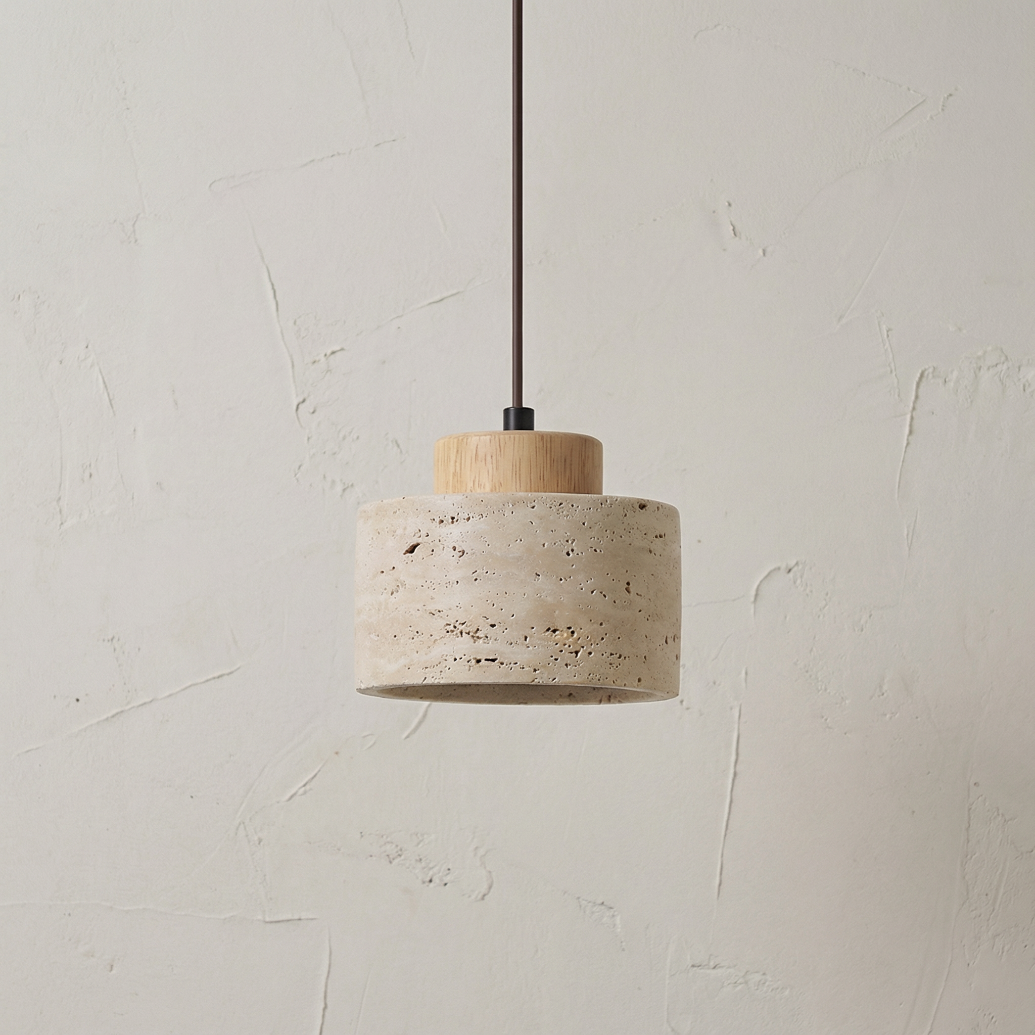 Vidar stone-effect sculptural pendant light in light finish above a dining table
