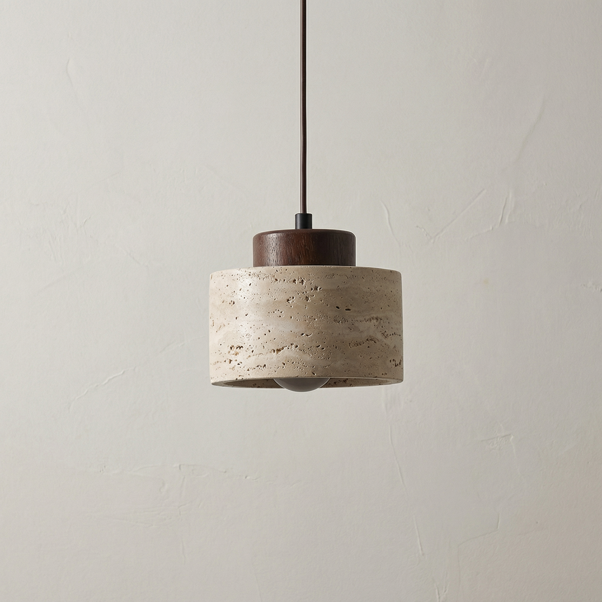 Vidar stone-effect sculptural pendant light in light finish above a dining table