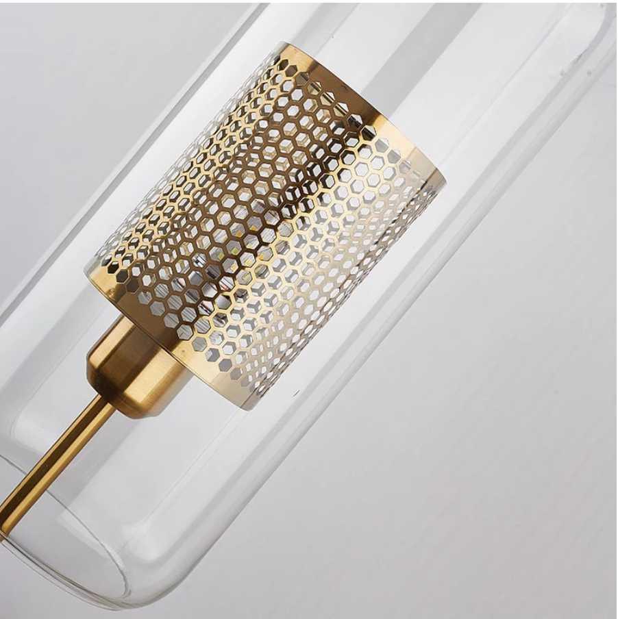 Alegria gold glass wall sconce flanking a bathroom mirror, casting warm light