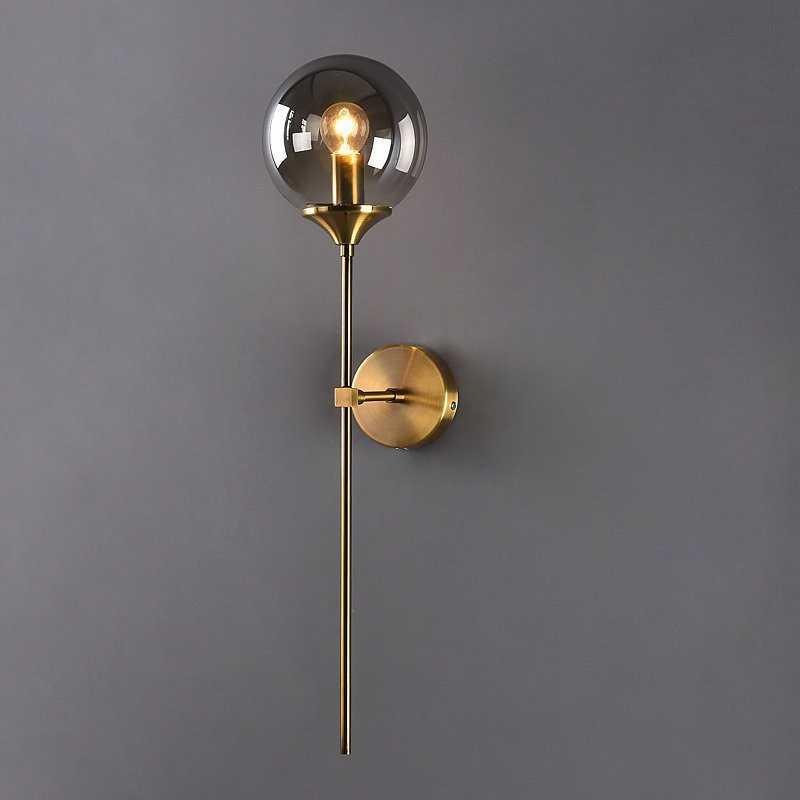 Annika amber glass ball wall sconce mounted in a dining room beside a mirror