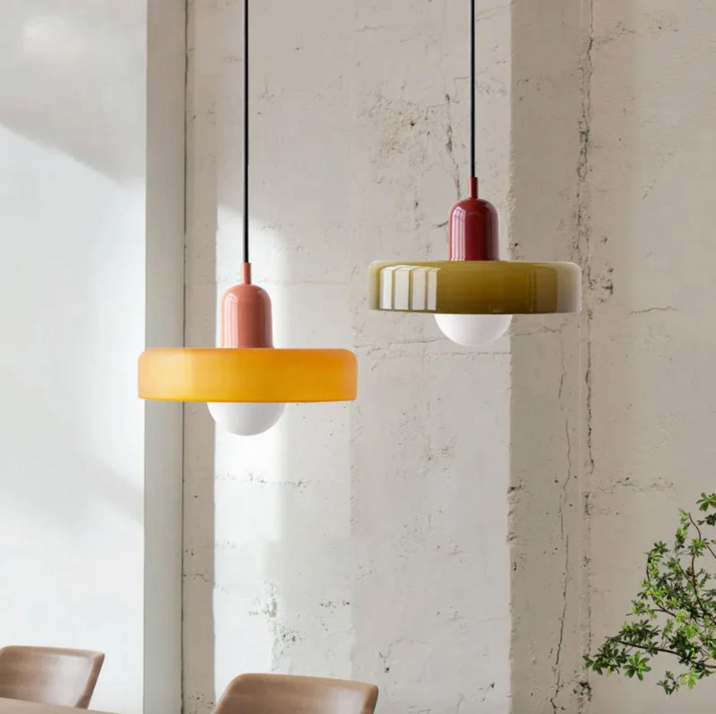 Kalle beige and white Bauhaus dual-tone glass pendant light hanging above a dining table