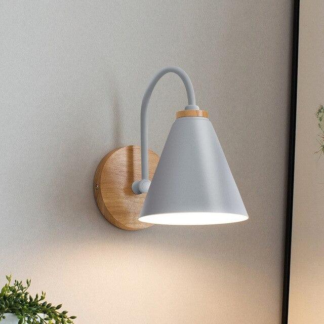 Saskia Nordic wall lamp in black with opal glass shade mounted in a contemporary bedroom