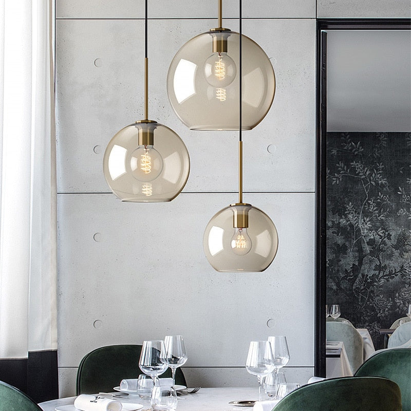 Millay cognac smoked glass pendant light in circle shape above a kitchen island