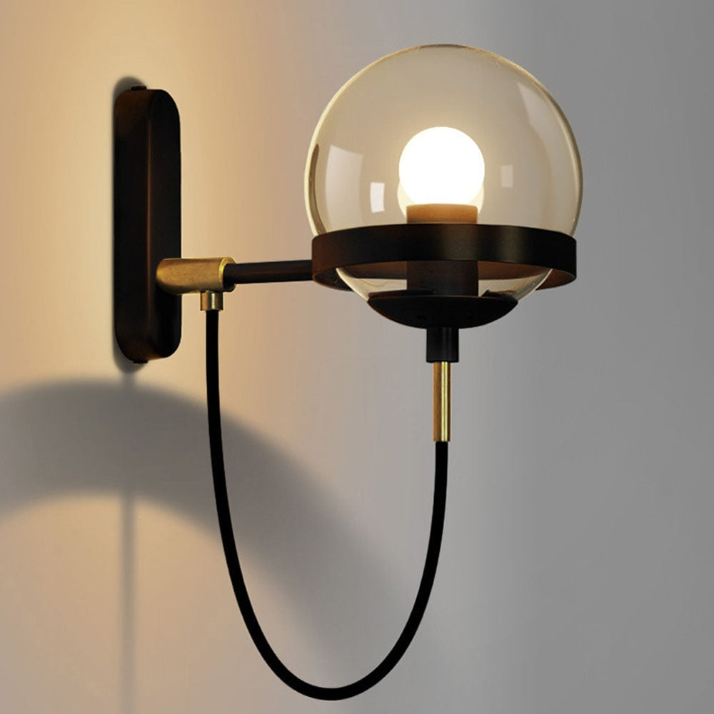 Höskulle glass ball wall sconce in black iron mounted in a bright hallway
