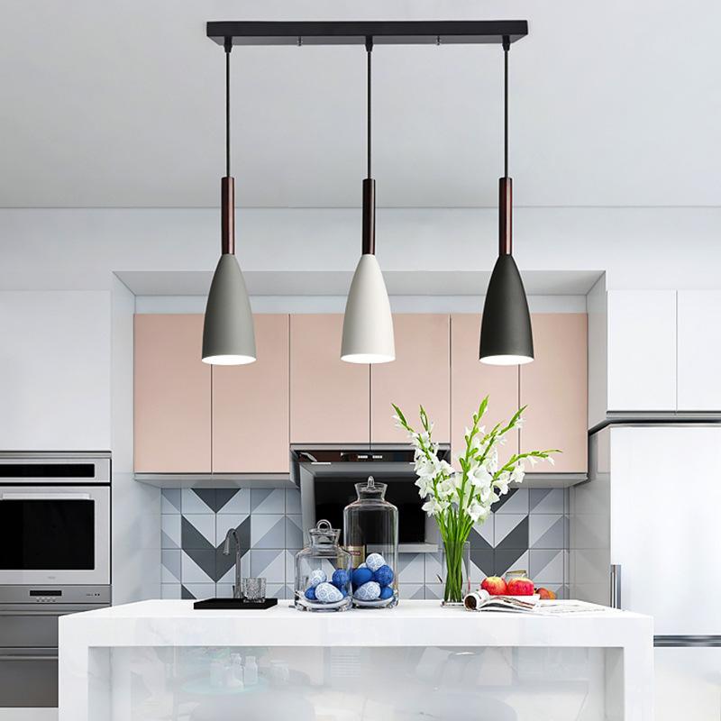 Trine triple aluminium pendant light in white above a kitchen island with adjustable cord lengths