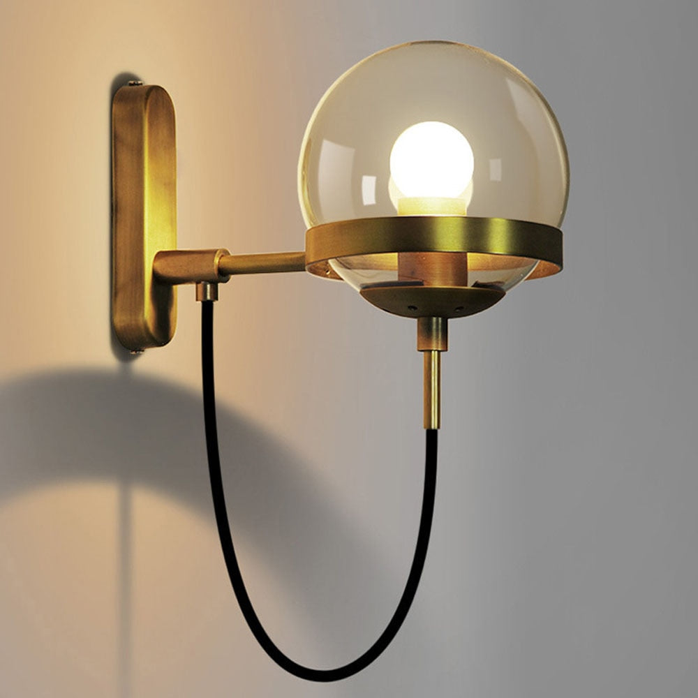 Höskulle glass ball wall sconce in black iron mounted in a bright hallway