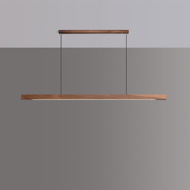 Lindö pine wood dining pendant light hanging low above a long dining table in a Nordic interior