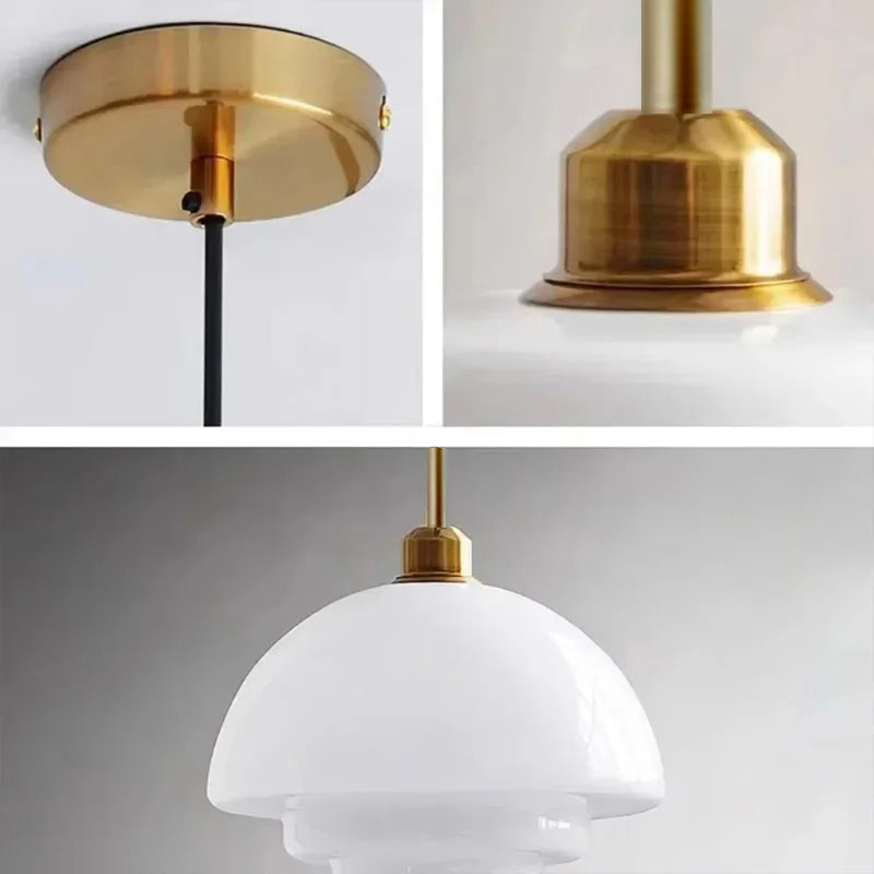 Opal milk glass pendant light hanging above a dining table, casting a soft warm glow