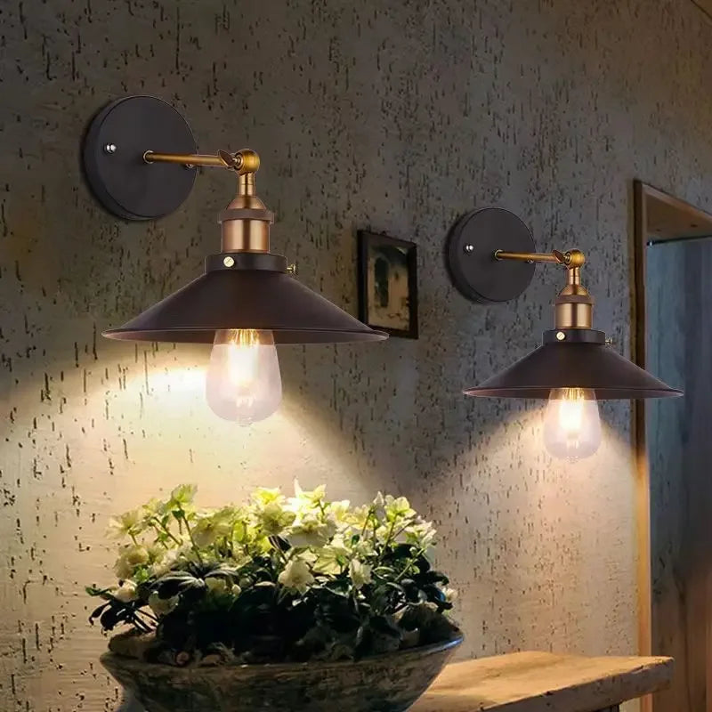 Edison industrial iron wall lamp in matte black mounted on a brick staircase wall