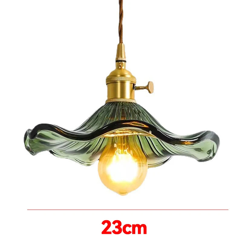 Prism green glass pendant light with copper fitting hanging in a dining room