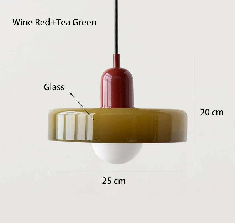 Bauhaus multi-pendant glass chandelier with orange shades hanging above a dining table in a café