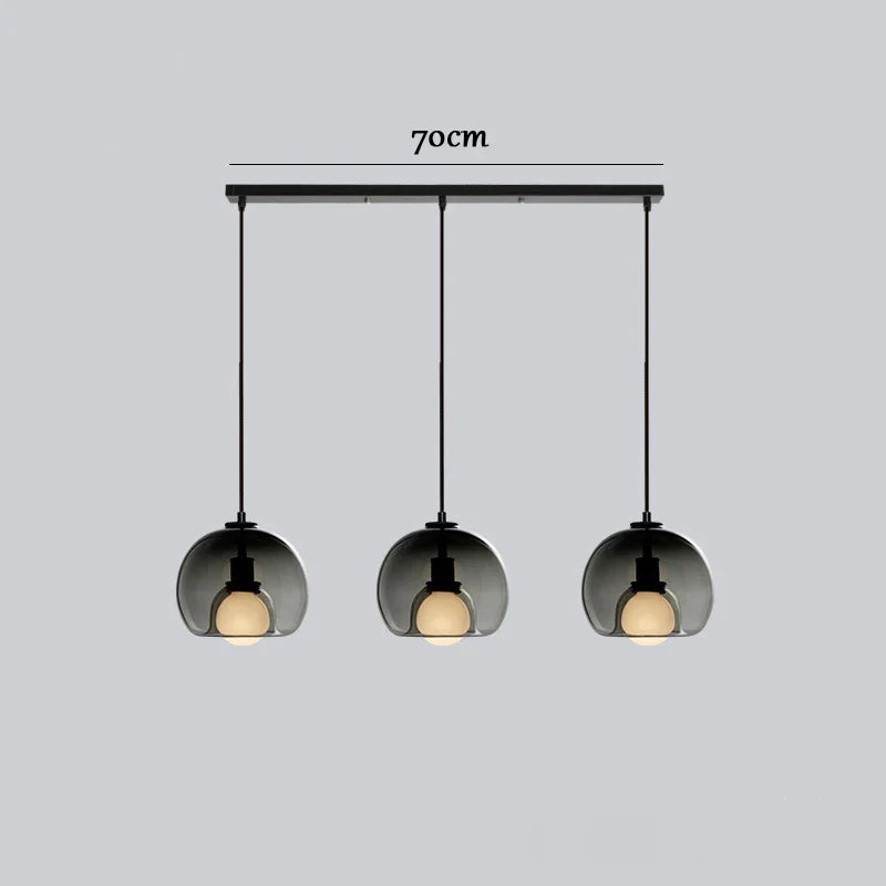 Anele smoke grey dome glass pendant light in a row of three above a kitchen island