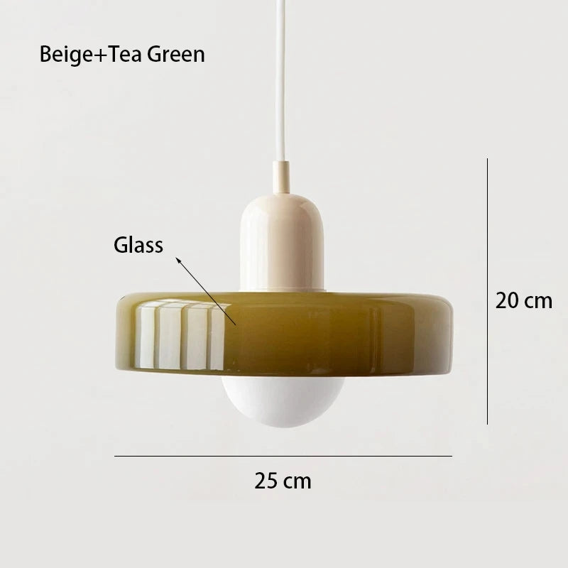 Bauhaus multi-pendant glass chandelier with orange shades hanging above a dining table in a café