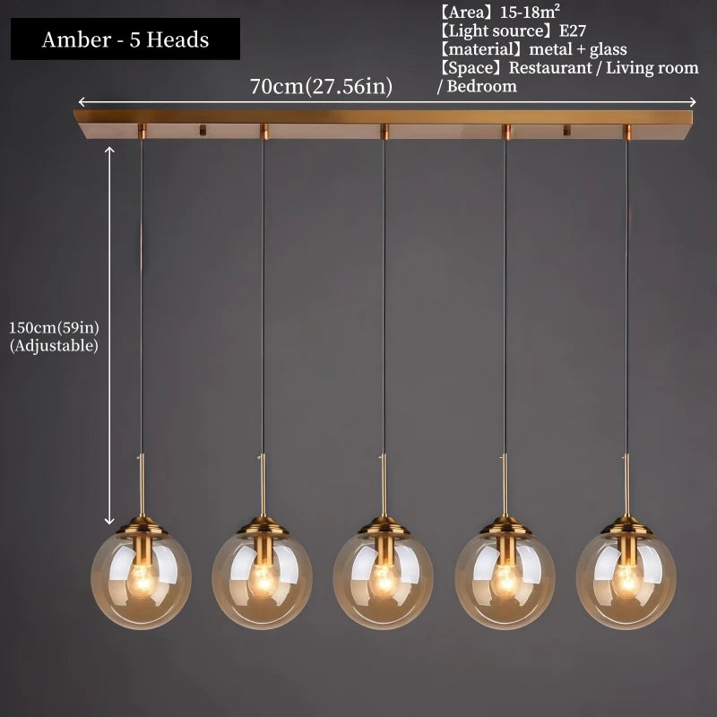 Orla amber glass and metal pendant light hanging above a bedside table in a Nordic-style bedroom