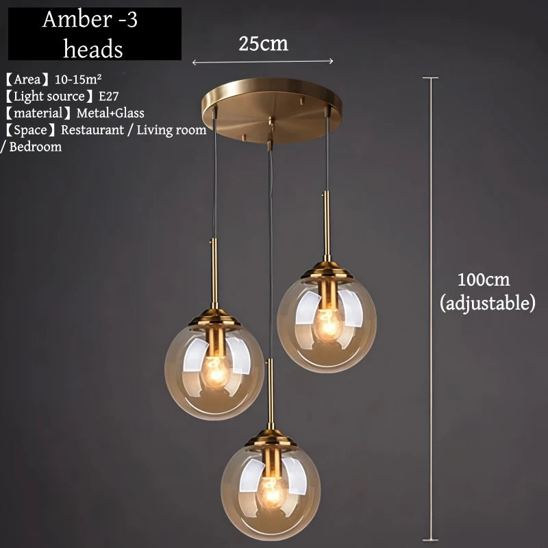 Orla amber glass and metal pendant light hanging above a bedside table in a Nordic-style bedroom