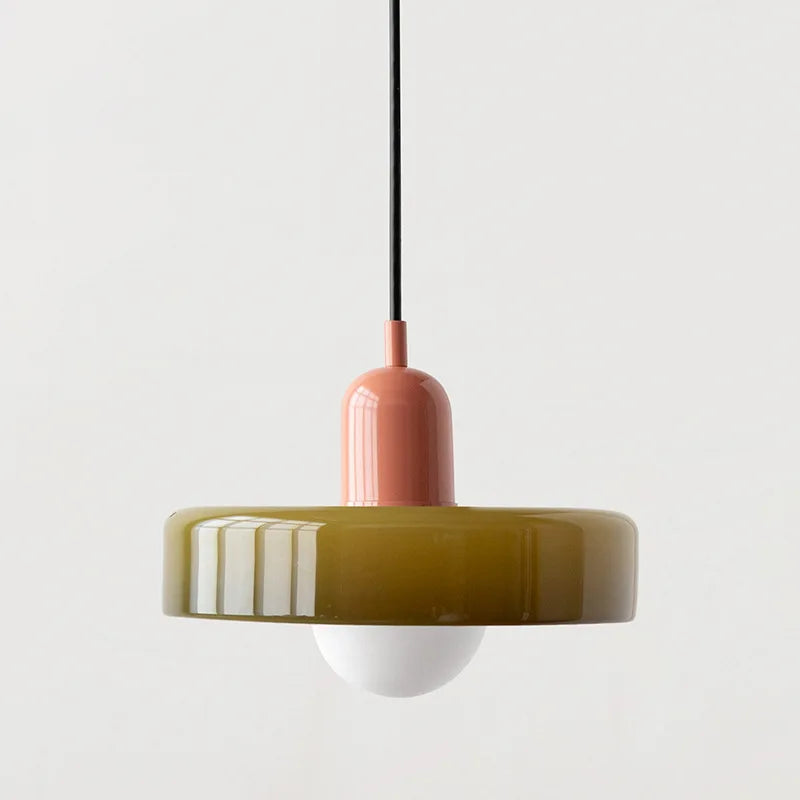 Bauhaus multi-pendant glass chandelier with orange shades hanging above a dining table in a café