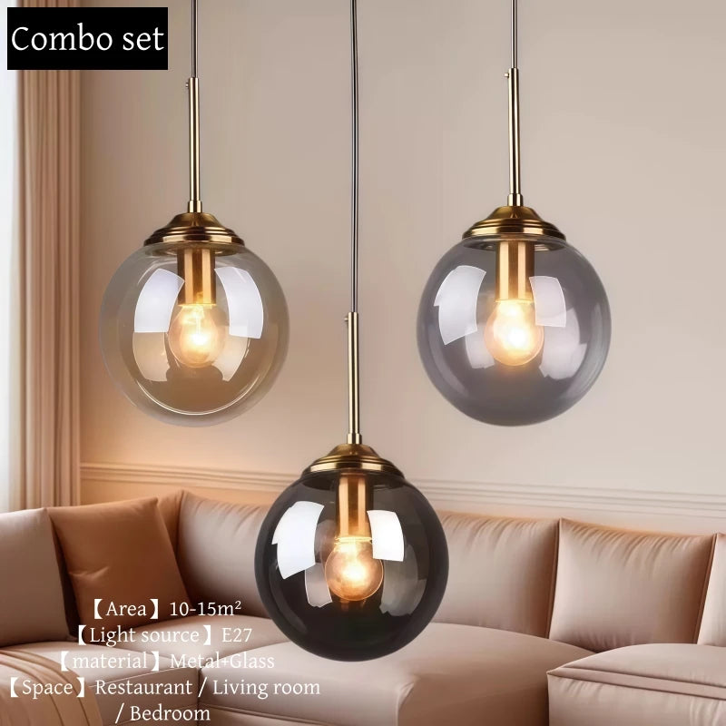 Orla amber glass and metal pendant light hanging above a bedside table in a Nordic-style bedroom