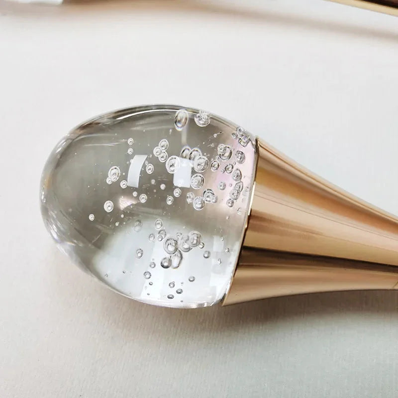 Dewdrop crystal cluster pendant light with multiple glass spheres hanging above a dining table