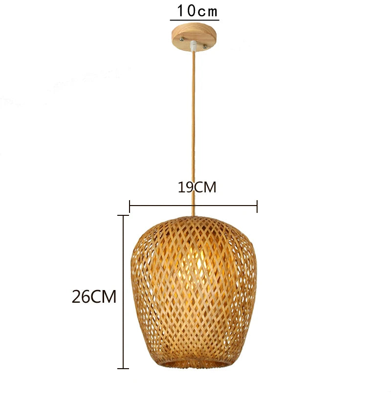 Wren handcrafted woven bamboo pendant light hanging above a wooden dining table in a warm interior