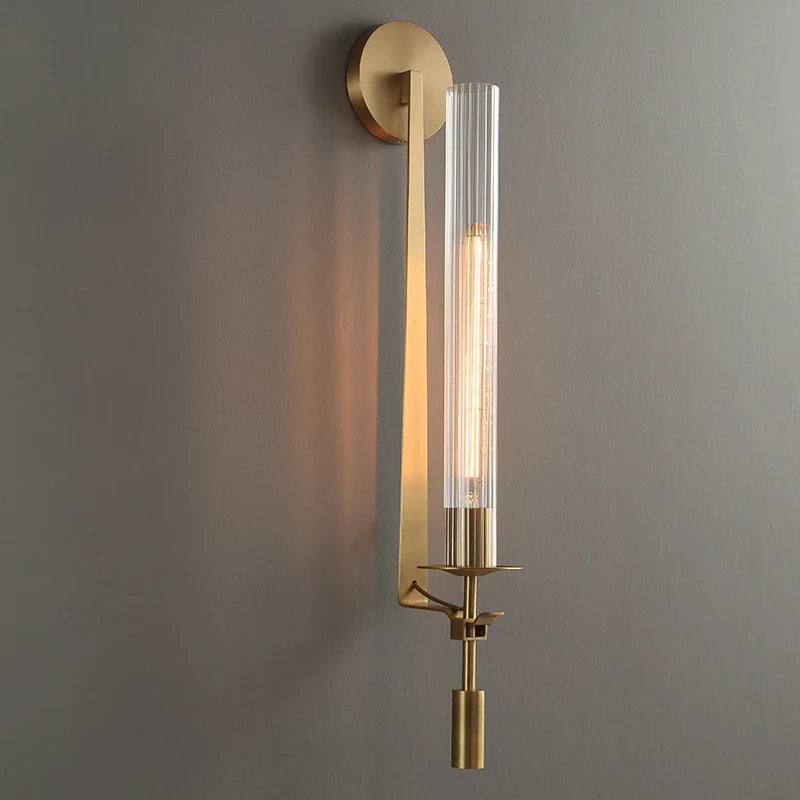 Dagny gold leaf wall sconce with glass element mounted flanking a bed