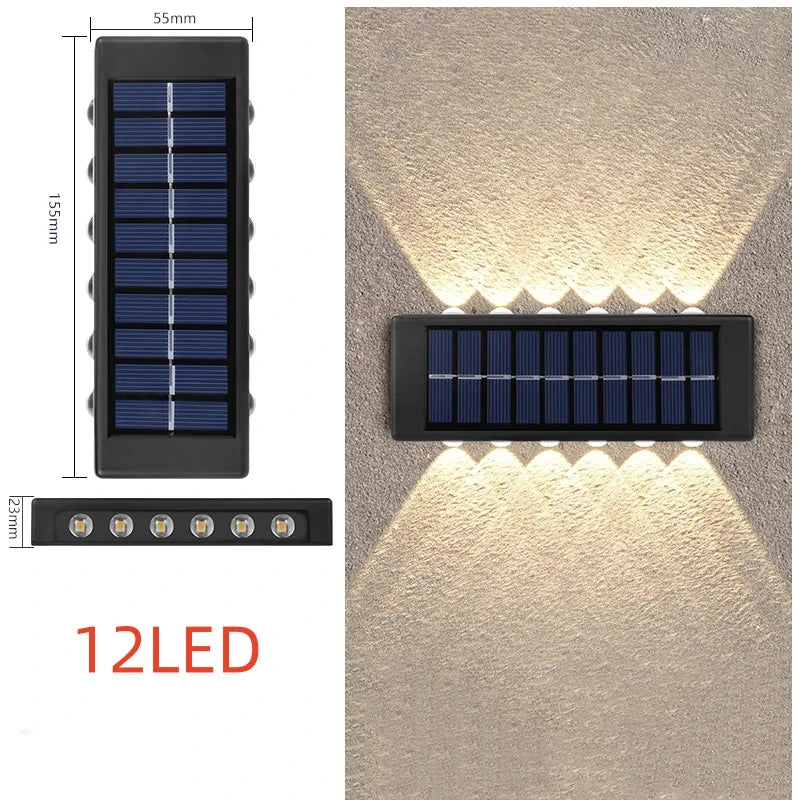 Solstice solar wall light mounted on a garden fence, illuminated at dusk