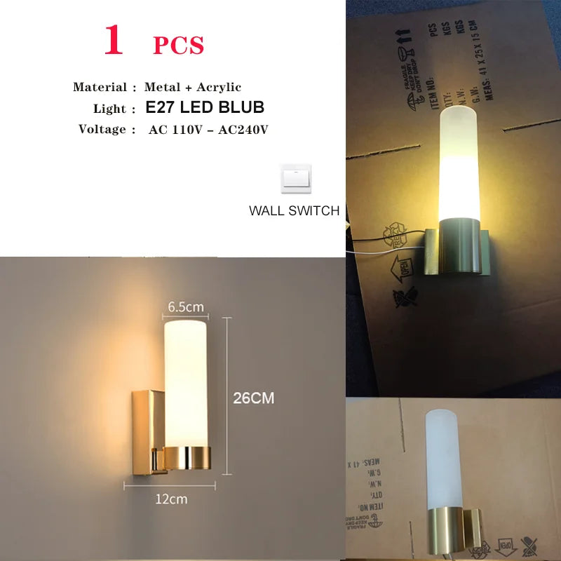 Harlow gold glass wall sconce with copper arm mounted in a living room beside an armchair