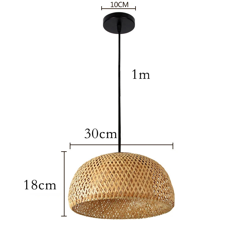 Wren handcrafted woven bamboo pendant light hanging above a wooden dining table in a warm interior