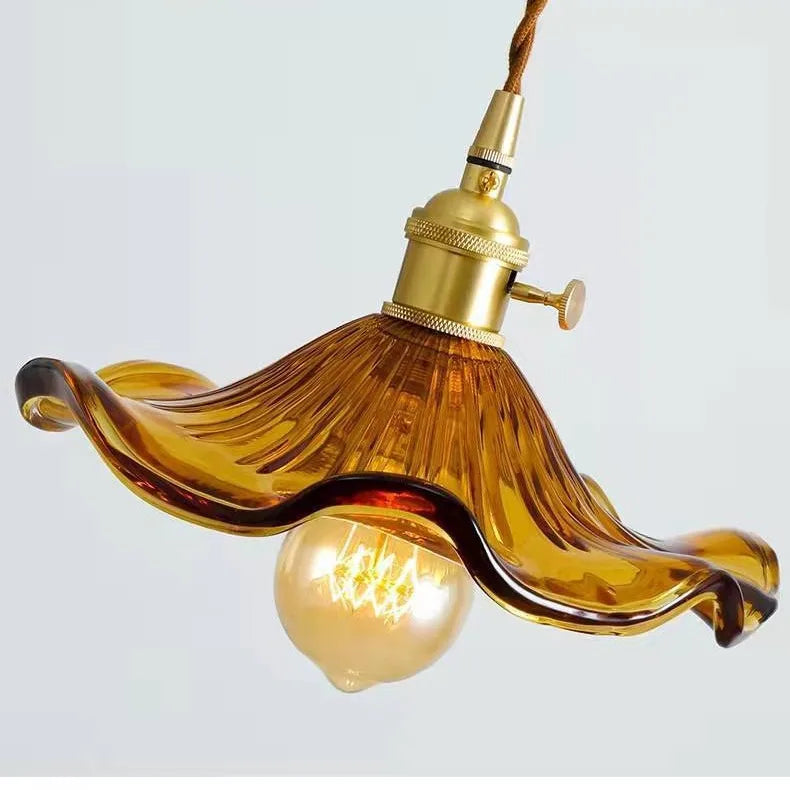 Prism green glass pendant light with copper fitting hanging in a dining room