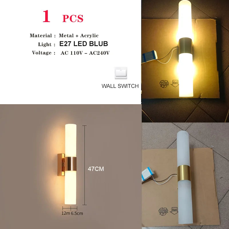 Harlow gold glass wall sconce with copper arm mounted in a living room beside an armchair