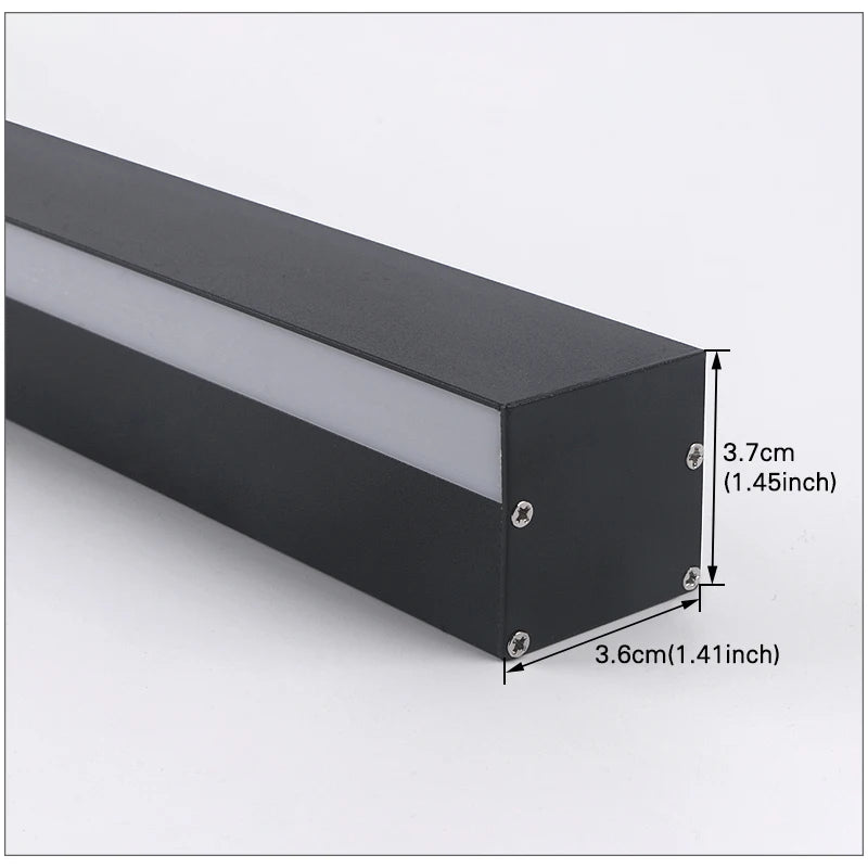Croft linear LED wall sconce mounted vertically beside a bedroom headboard, casting a warm wash of light
