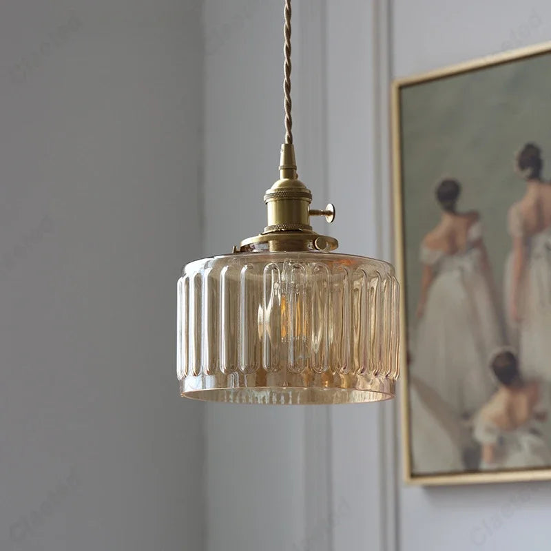 Vessel vintage glass wall lamp mounted beside a bedroom window casting warm ambient light