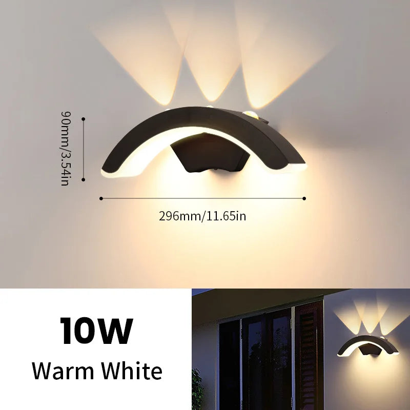 Hadley IP66 weatherproof outdoor wall lantern in black, mounted on a rendered exterior wall