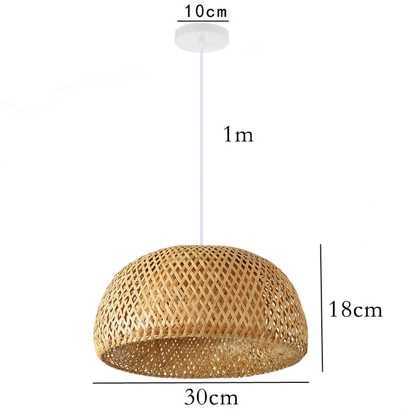 Wren handcrafted woven bamboo pendant light hanging above a wooden dining table in a warm interior