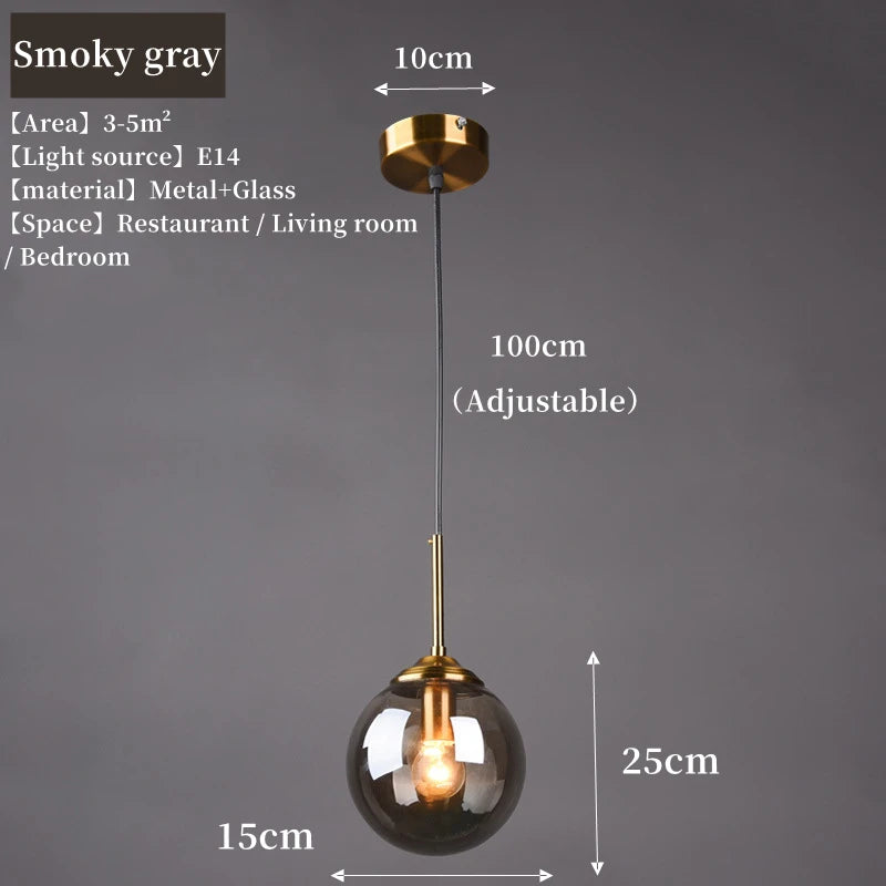 Orla amber glass and metal pendant light hanging above a bedside table in a Nordic-style bedroom