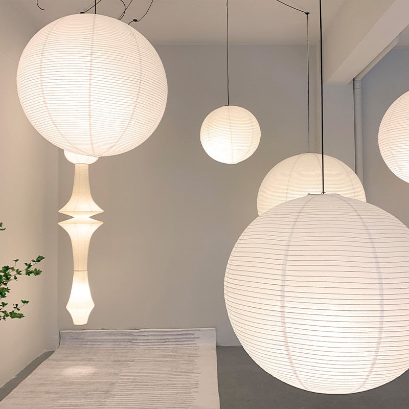 Linnea natural rattan pendant light hanging above a wooden dining table in a Nordic interior