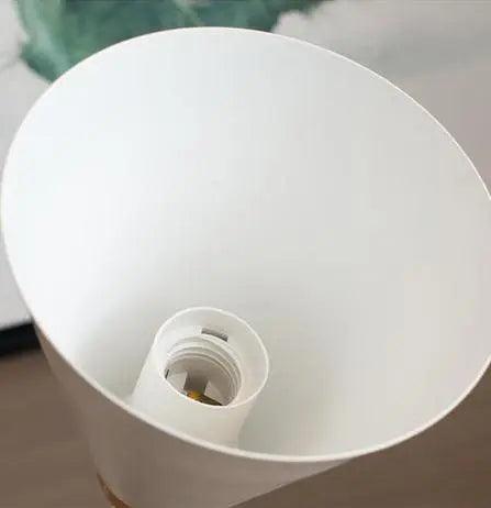 Saskia Nordic wall lamp in black with opal glass shade mounted in a contemporary bedroom
