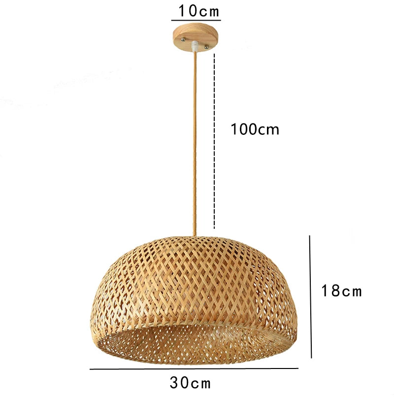 Wren handcrafted woven bamboo pendant light hanging above a wooden dining table in a warm interior