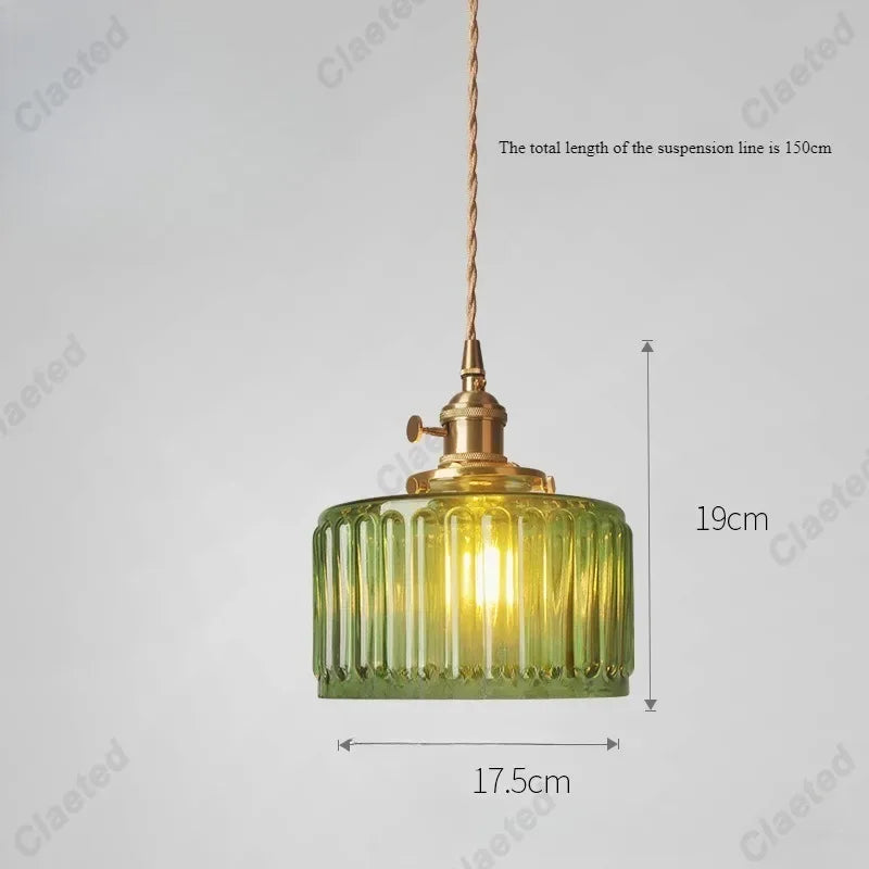 Vessel vintage glass wall lamp mounted beside a bedroom window casting warm ambient light