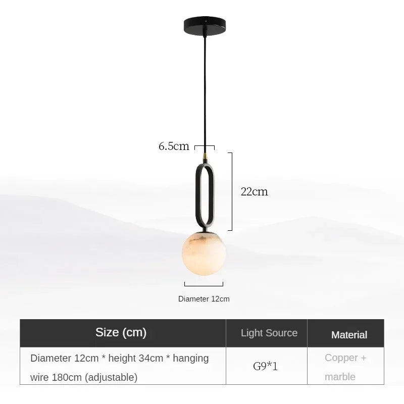 Hulda natural marble pendant light with copper accents above a formal dining table