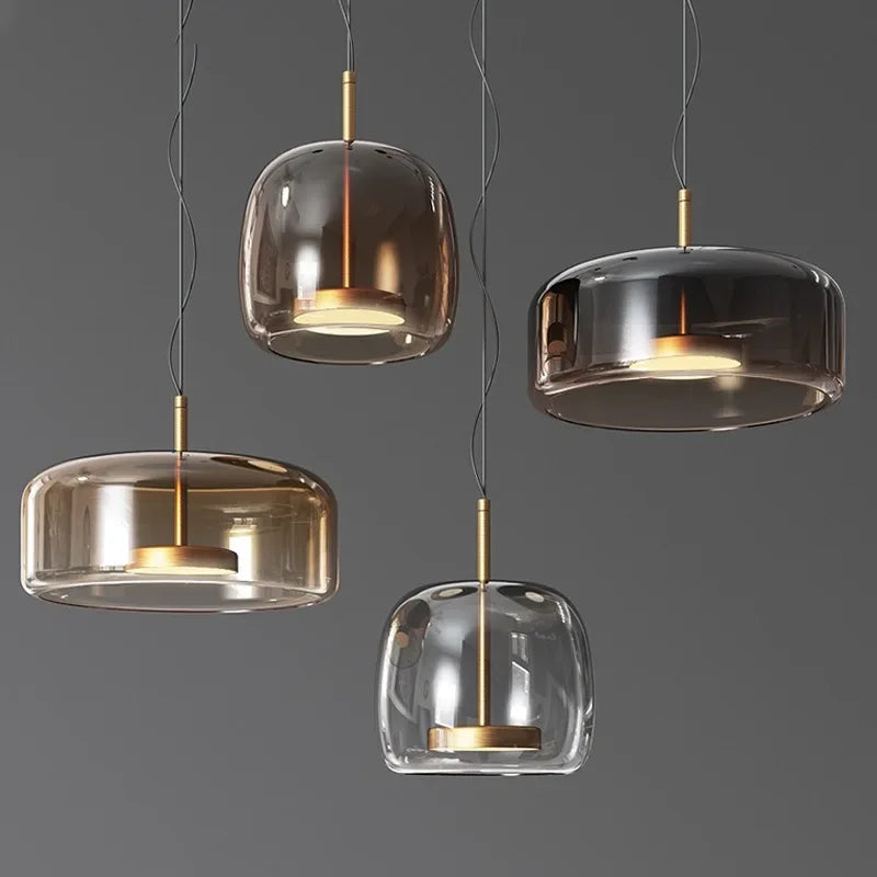 Astrid amber glass Nordic pendant light with gold fitting above a dining table