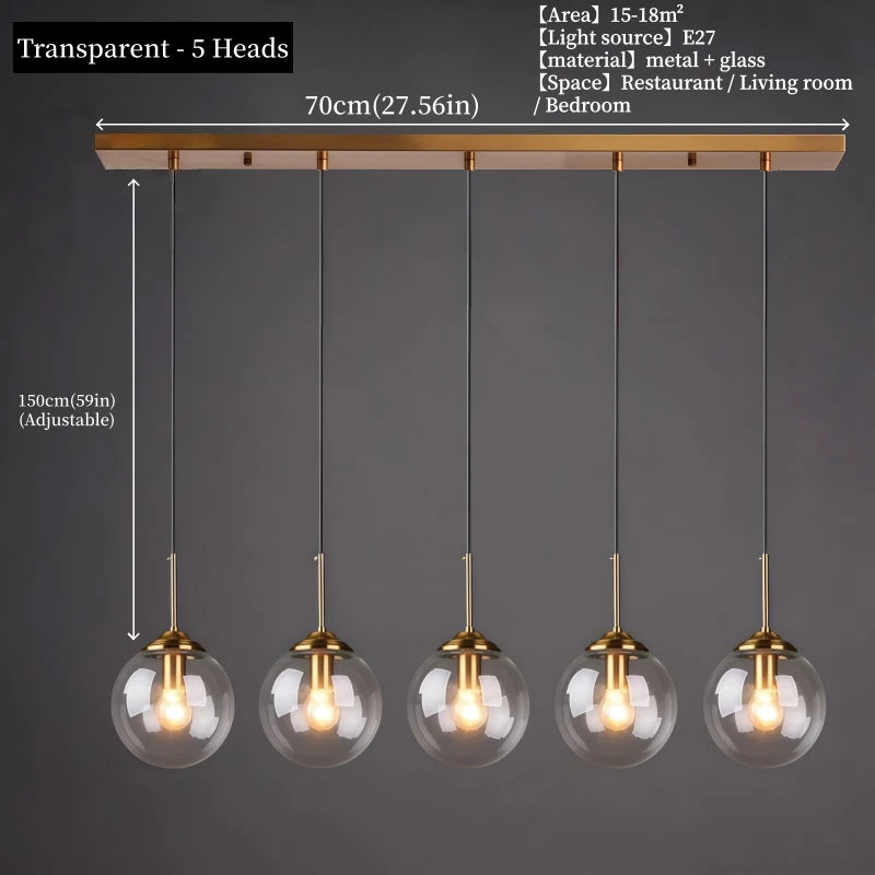 Orla amber glass and metal pendant light hanging above a bedside table in a Nordic-style bedroom