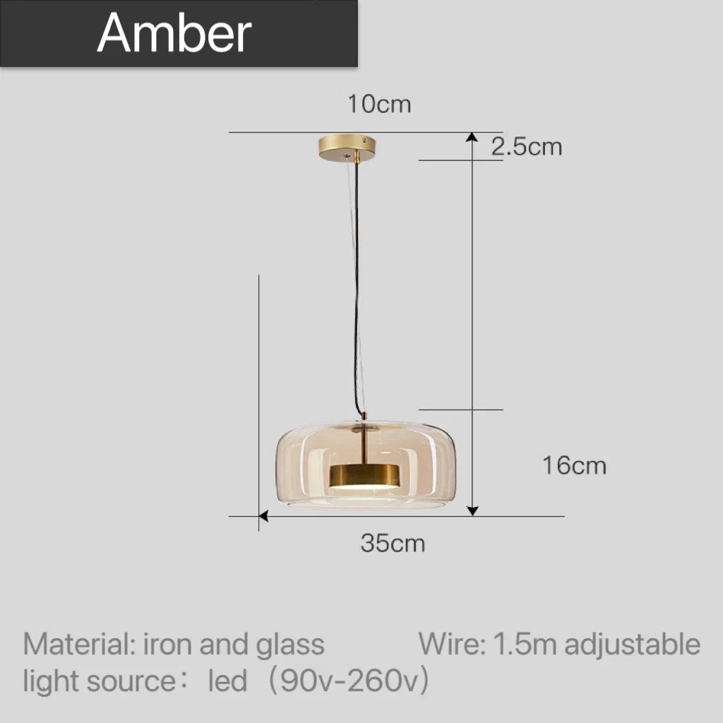 Astrid amber glass Nordic pendant light with gold fitting above a dining table
