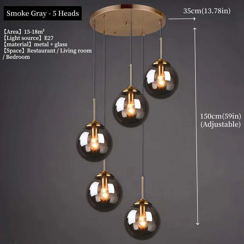 Orla amber glass and metal pendant light hanging above a bedside table in a Nordic-style bedroom