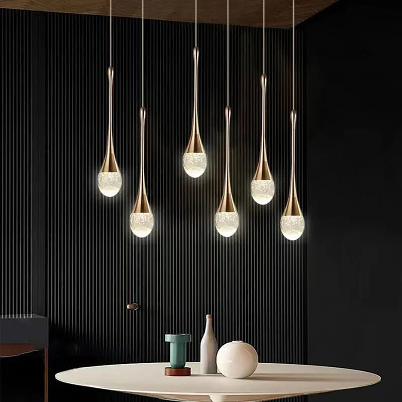 Dewdrop crystal cluster pendant light with multiple glass spheres hanging above a dining table
