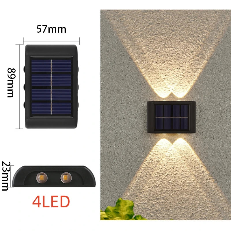 Solstice solar wall light mounted on a garden fence, illuminated at dusk