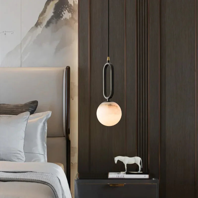 Hulda natural marble pendant light with copper accents above a formal dining table