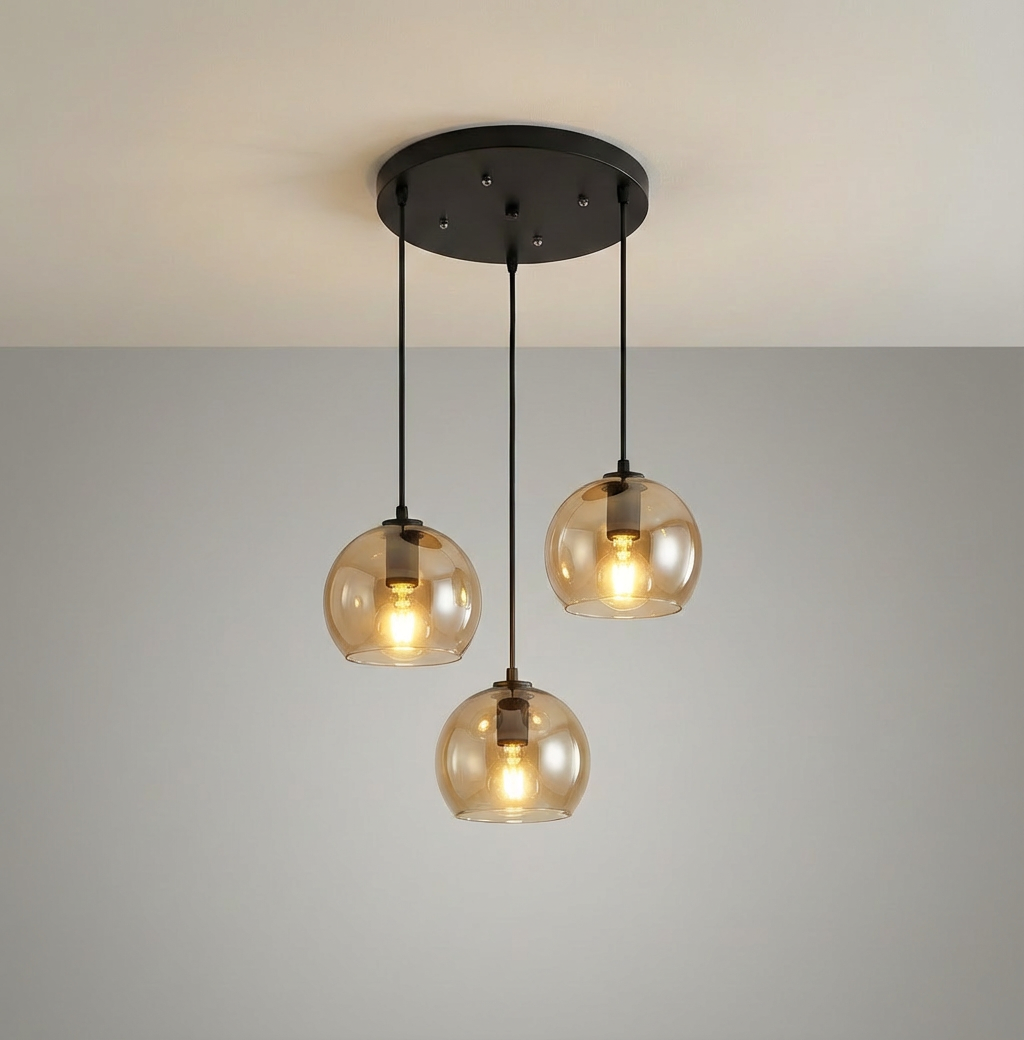 Anele smoke grey dome glass pendant light in a row of three above a kitchen island