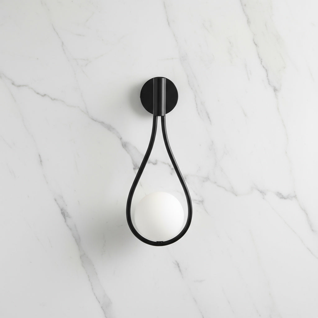 Livi gold Nordic wall sconce mounted beside a bed in a minimalist bedroom