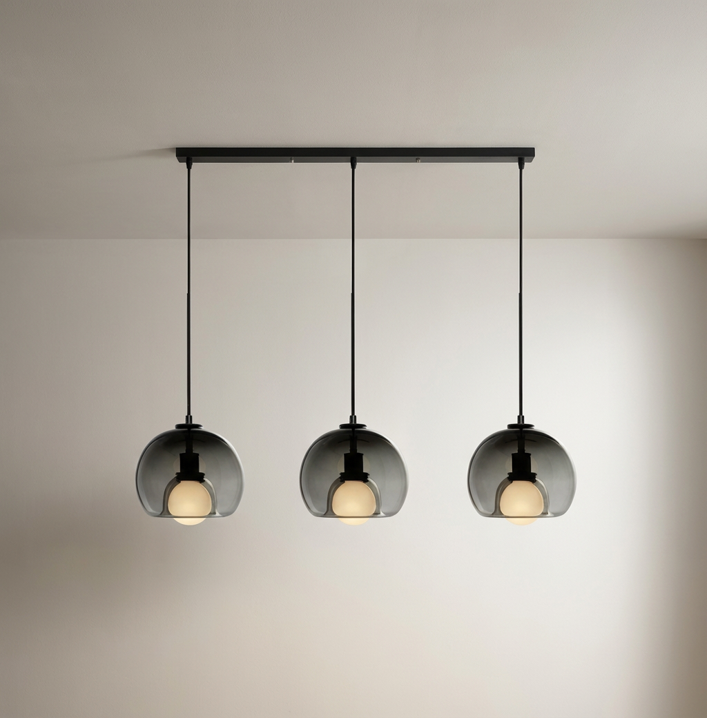 Anele smoke grey dome glass pendant light in a row of three above a kitchen island