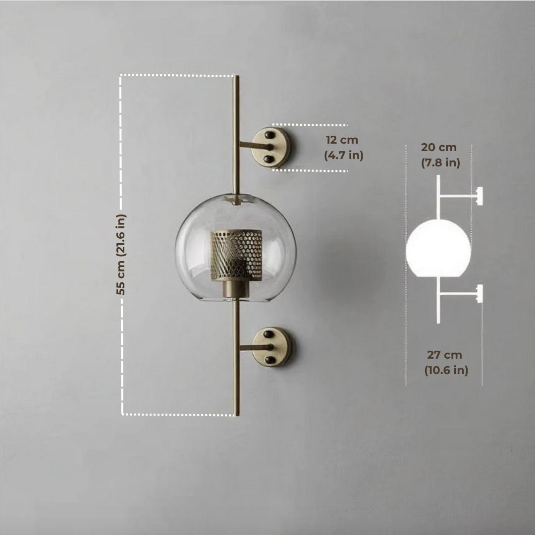 Alegria gold glass wall sconce flanking a bathroom mirror, casting warm light